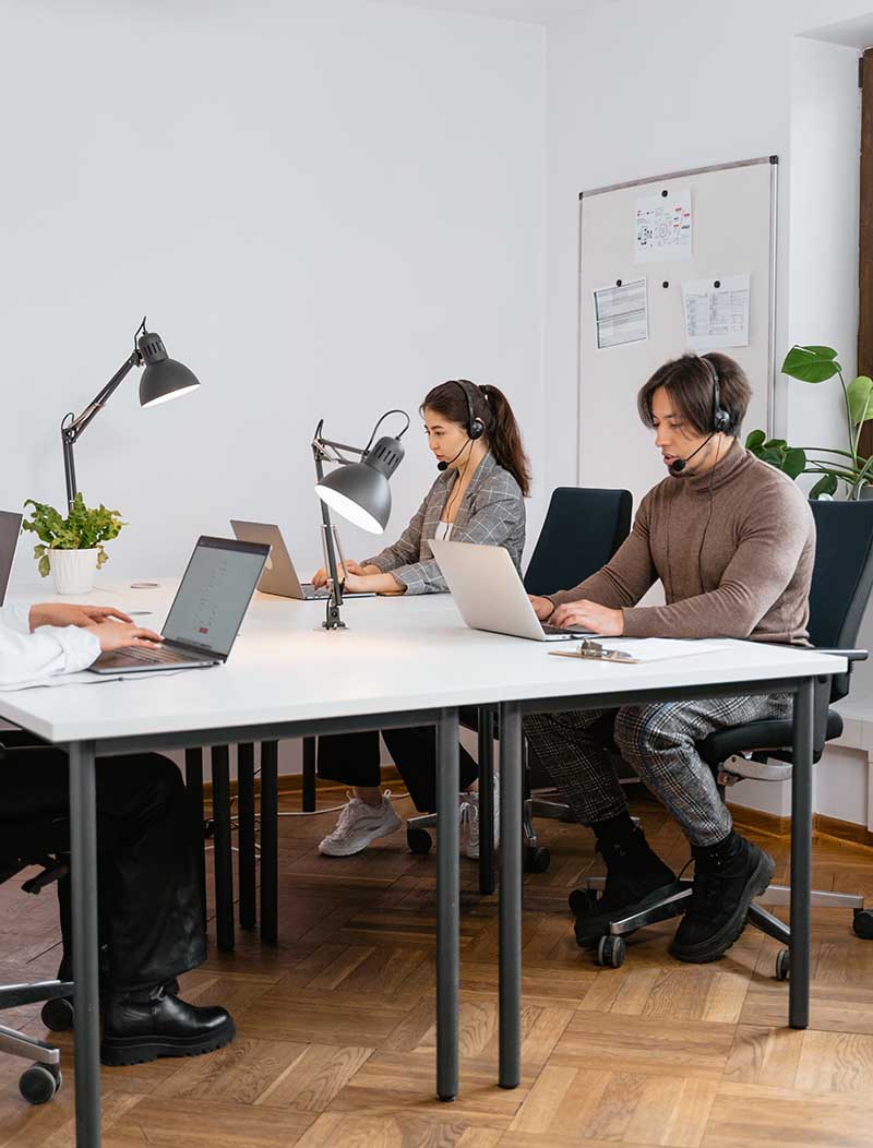 Office with works at desks.
